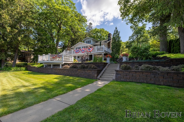 2625 Elmwood Dr, Pierson, MI 49339 - view of front of property with stairway, a deck, a front lawn, and a chimney