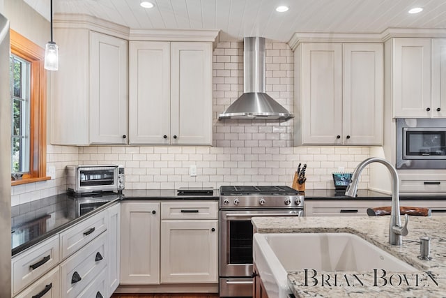 2625 Elmwood Dr, Pierson, MI 49339 - kitchen featuring appliances with stainless steel finishes, wall chimney exhaust hood, recessed lighting, backsplash, and dark stone countertops