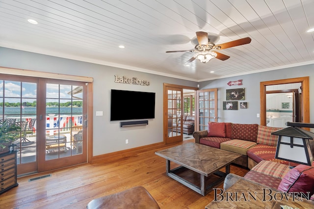 2625 Elmwood Dr, Pierson, MI 49339 - living room featuring french doors, healthy amount of natural light, light wood-style flooring, a ceiling fan, and crown molding