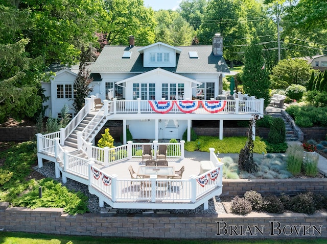 2625 Elmwood Dr, Pierson, MI 49339 - back of house with stairs, a wooden deck, a chimney, and roof with shingles