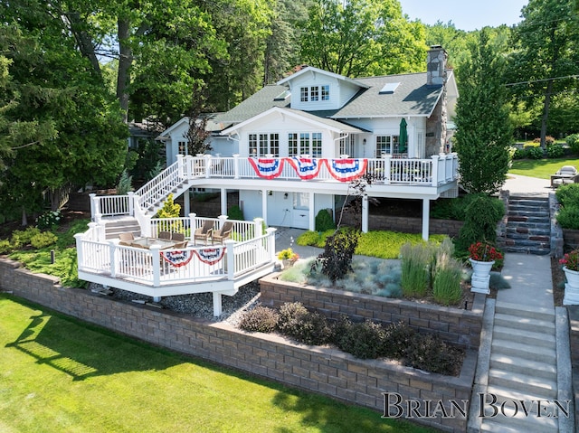 2625 Elmwood Dr, Pierson, MI 49339 - back of property with stairs, a wooden deck, a chimney, roof with shingles, and a yard