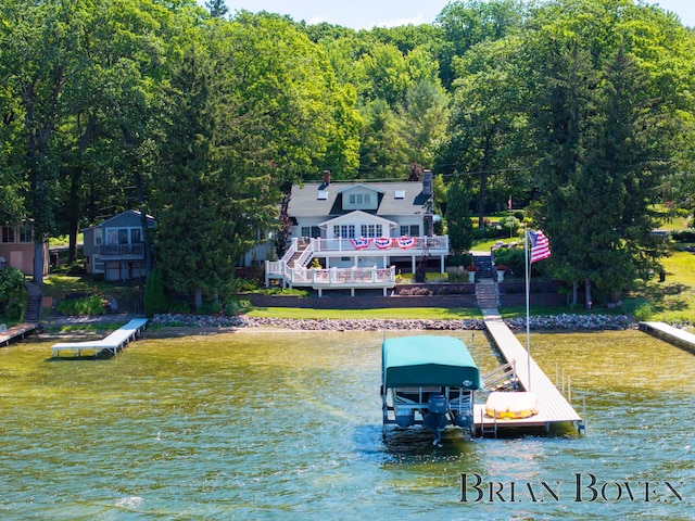 2625 Elmwood Dr, Pierson, MI 49339 - dock area with boat lift, a water view, and a forest view