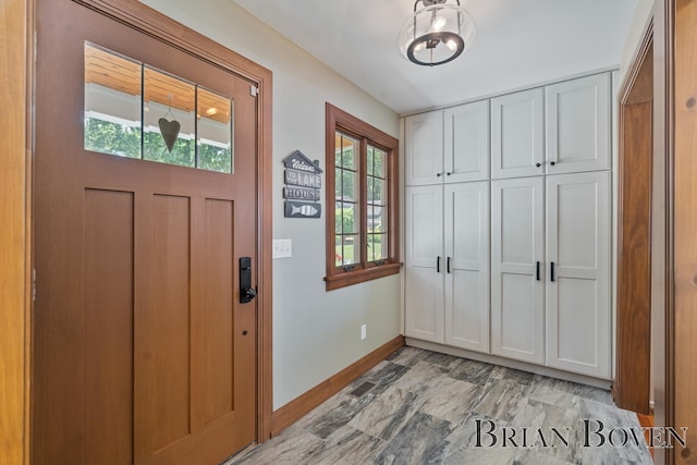 2625 Elmwood Dr, Pierson, MI 49339 - entryway featuring baseboards and a chandelier