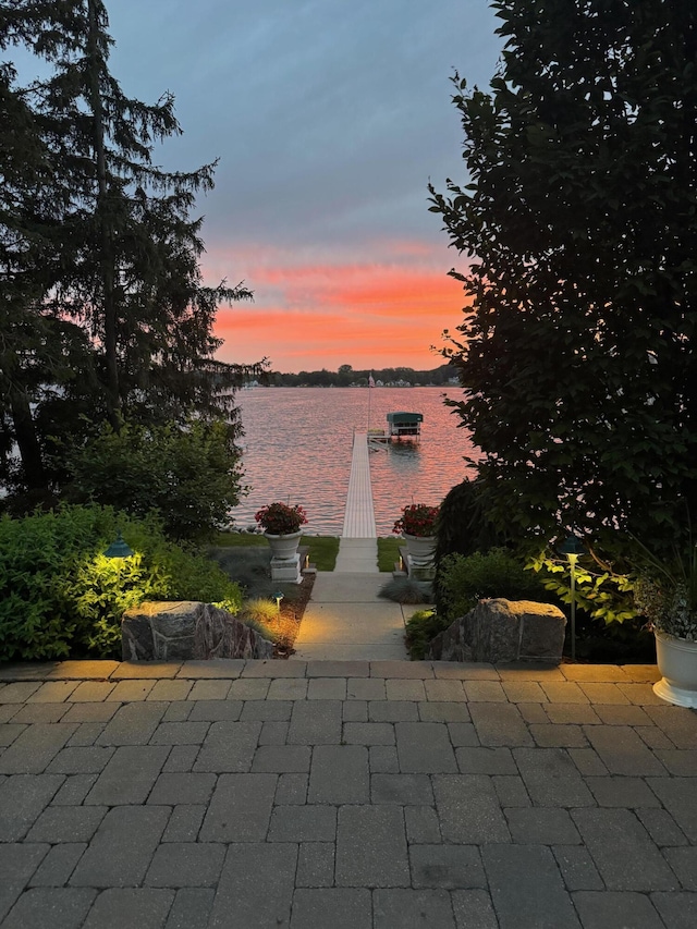 2625 Elmwood Dr, Pierson, MI 49339 - patio terrace at dusk featuring a water view
