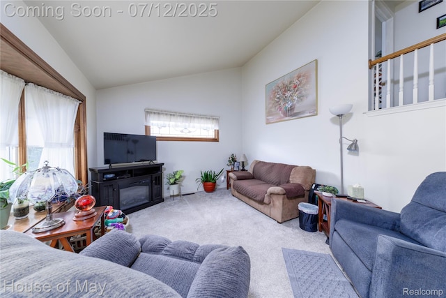 36827 Weideman, Clinton Township, MI 48035 - living room featuring carpet, lofted ceiling, and a glass covered fireplace
