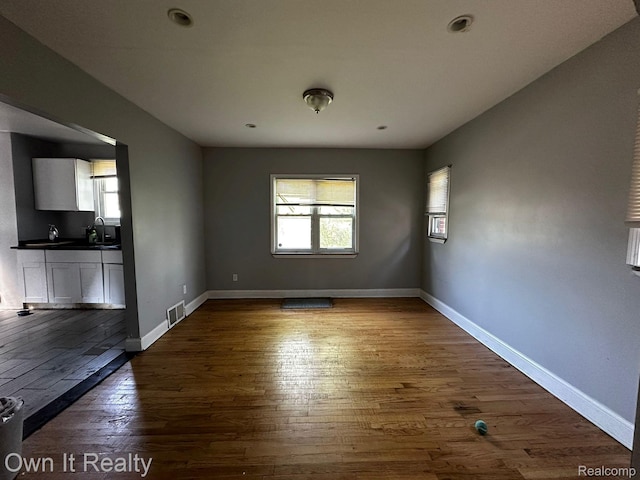 16595 Griggs St, Detroit, MI 48221 - unfurnished living room featuring dark wood-type flooring and a sink