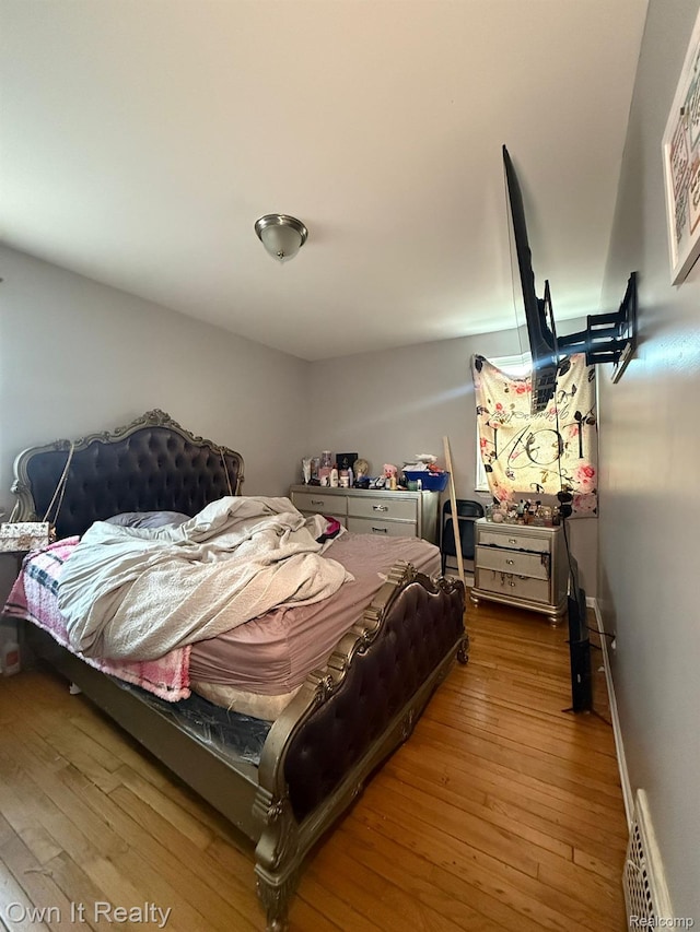 16595 Griggs St, Detroit, MI 48221 - bedroom featuring hardwood / wood-style flooring and a baseboard heating unit