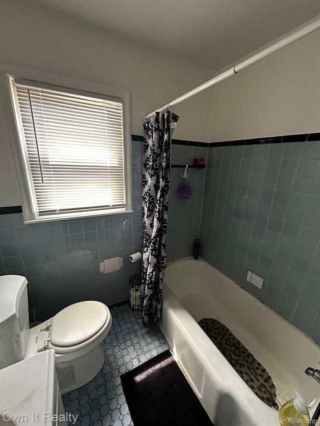 19505 Sunderland Rd, Detroit, MI 48219 - bathroom with tile walls, shower / bathtub combination with curtain, vanity, and a wainscoted wall