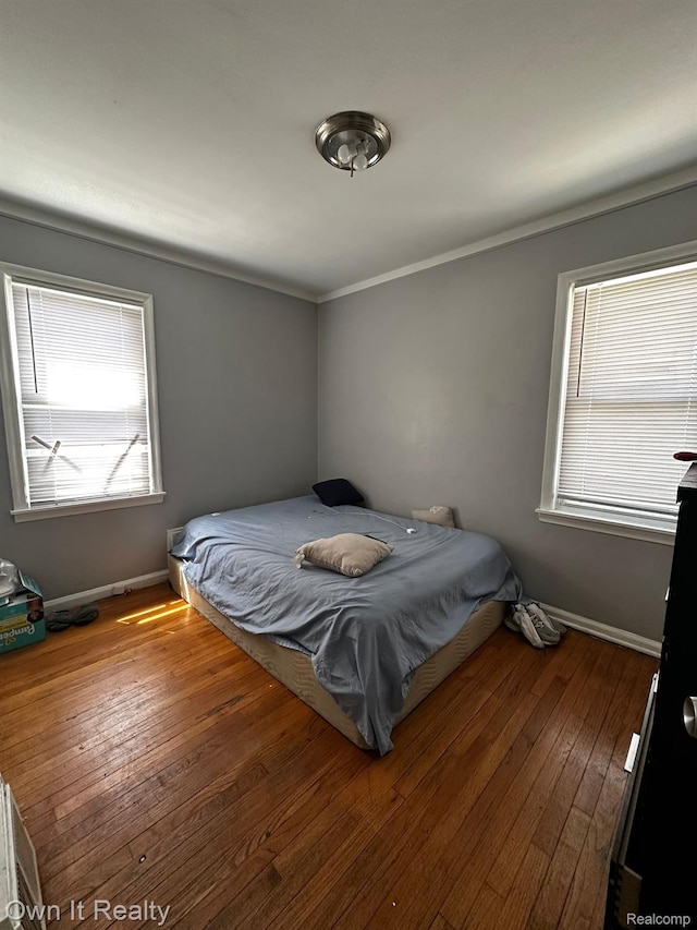 19505 Sunderland Rd, Detroit, MI 48219 - bedroom featuring multiple windows, wood-type flooring, and crown molding