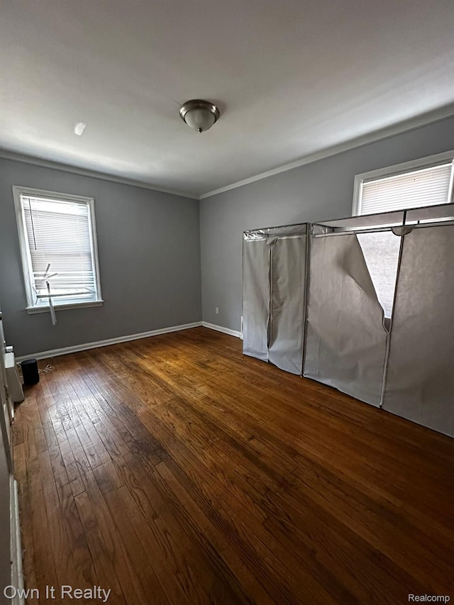 19505 Sunderland Rd, Detroit, MI 48219 - unfurnished bedroom featuring dark wood-type flooring and ornamental molding