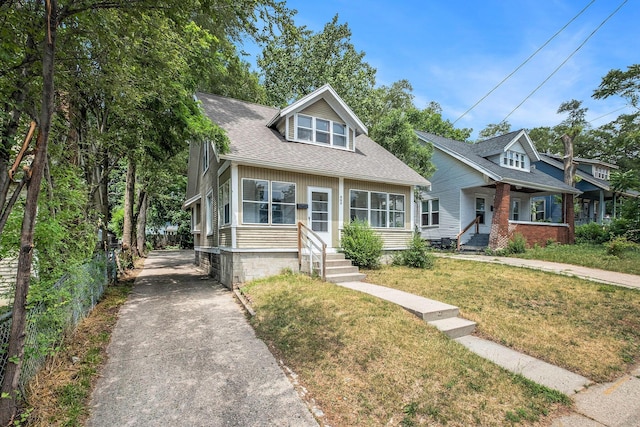863 Burton St SE, Grand Rapids, MI 49507 - bungalow-style house featuring driveway, a front yard, a shingled roof, and entry steps