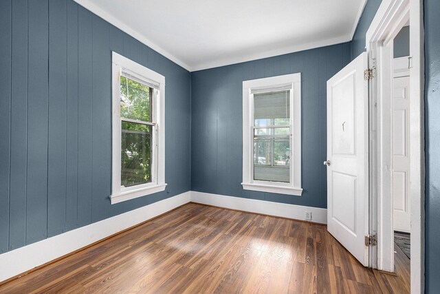 863 Burton St SE, Grand Rapids, MI 49507 - empty room with dark wood-style floors and ornamental molding