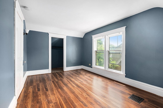 863 Burton St SE, Grand Rapids, MI 49507 - unfurnished bedroom featuring lofted ceiling, wood finished floors, and a closet
