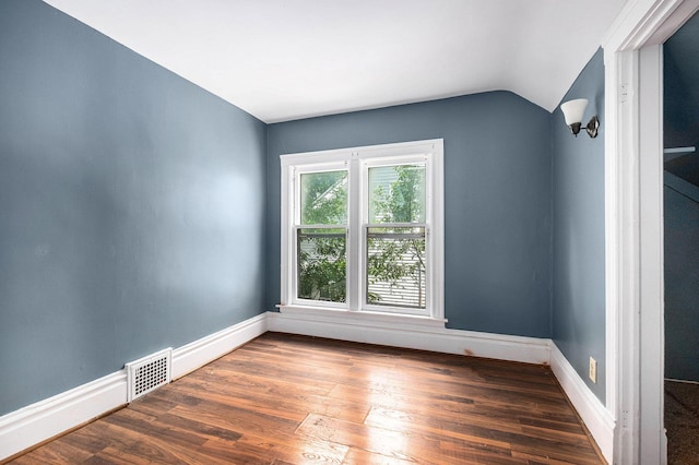 863 Burton St SE, Grand Rapids, MI 49507 - empty room featuring lofted ceiling and wood finished floors