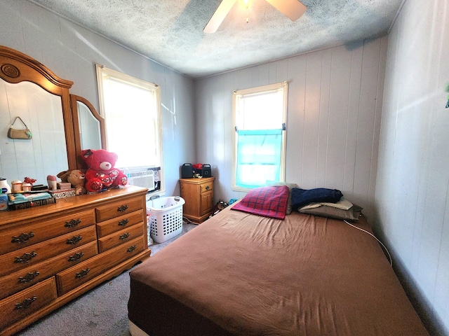 2258 Mckee Ave SW, Grand Rapids, MI 49503 - carpeted bedroom with a textured ceiling, a ceiling fan, and cooling unit