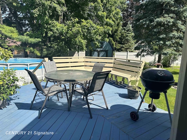 324 Pine St, Clio, MI 48420 - wooden terrace with a shed, outdoor dining area, a fenced backyard, and a grill