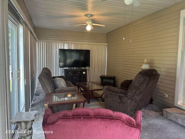 324 Pine St, Clio, MI 48420 - living area with carpet flooring, ceiling fan, and wood walls