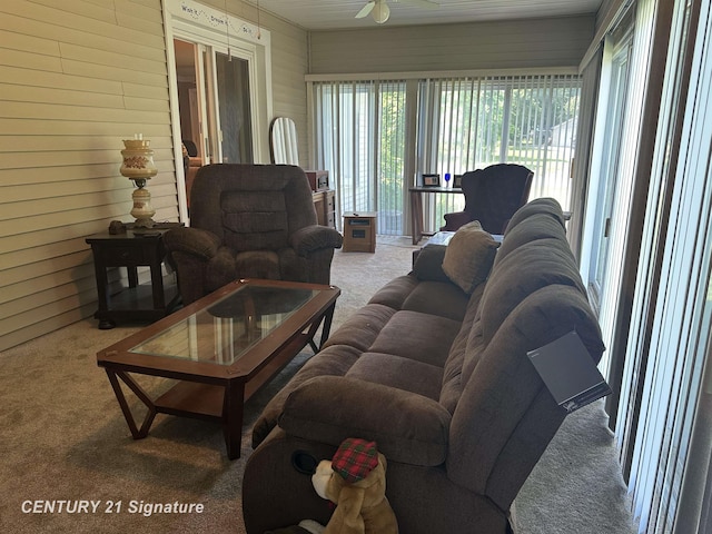 324 Pine St, Clio, MI 48420 - living area featuring carpet floors, a ceiling fan, and wooden walls