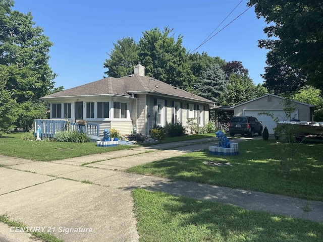 324 Pine St, Clio, MI 48420 - ranch-style house with a front lawn, a chimney, a sunroom, and an outbuilding
