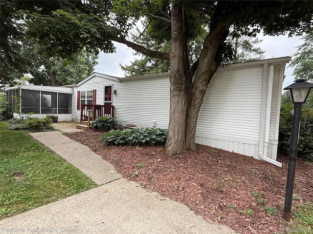 26852 Roric St, Novi, MI 48377 - view of side of home featuring a sunroom