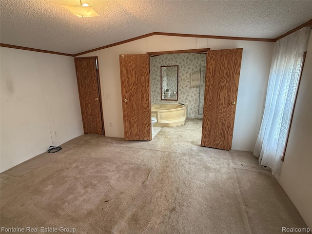 26852 Roric St, Novi, MI 48377 - unfurnished bedroom with lofted ceiling, crown molding, carpet flooring, a textured ceiling, and ensuite bathroom