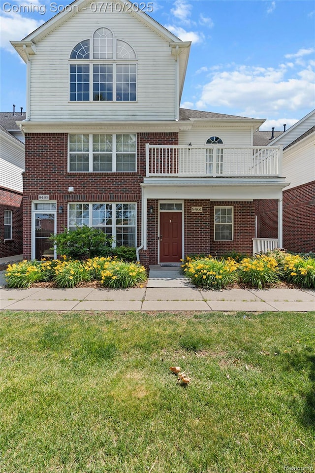 8461 Towne Center Cir N, Warren, MI 48093 - view of front of home featuring a balcony, a front lawn, and brick siding