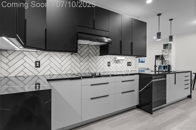 8461 Towne Center Cir N, Warren, MI 48093 - kitchen featuring dark cabinets, dark countertops, backsplash, light wood-type flooring, and under cabinet range hood