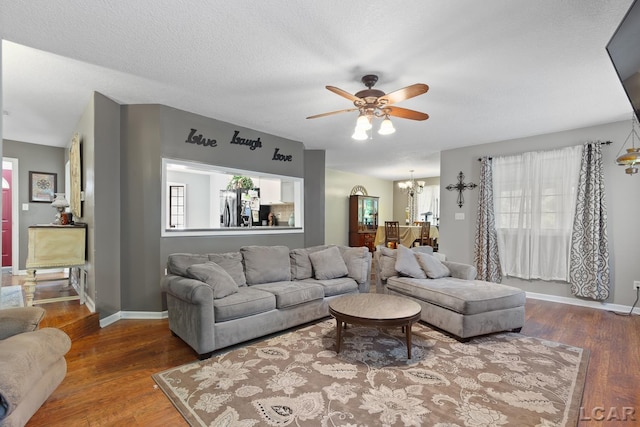 15858 Lelah Ln, Addison, MI 49220 - living room featuring a ceiling fan, a chandelier, and wood finished floors