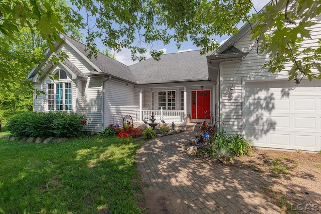 15858 Lelah Ln, Addison, MI 49220 - view of front of property with an attached garage, a porch, a front lawn, and roof with shingles