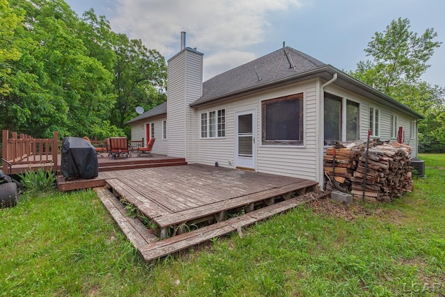 15858 Lelah Ln, Addison, MI 49220 - rear view of house with a yard, a chimney, a deck, and roof with shingles