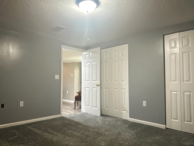 15858 Lelah Ln, Addison, MI 49220 - unfurnished bedroom with carpet flooring, a textured ceiling, and two closets