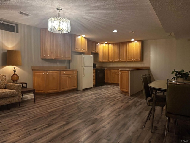 15858 Lelah Ln, Addison, MI 49220 - kitchen featuring freestanding refrigerator, a chandelier, dark wood finished floors, stove, and pendant lighting