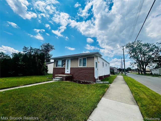 3948 10th St, Ecorse, MI 48229 - view of front facade with brick siding and a front lawn