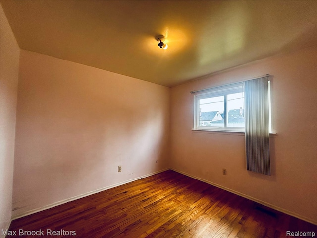 3948 10th St, Ecorse, MI 48229 - empty room with wood finished floors and baseboards