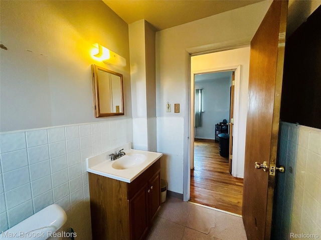 3948 10th St, Ecorse, MI 48229 - half bathroom with tile walls, vanity, a wainscoted wall, and tile patterned flooring