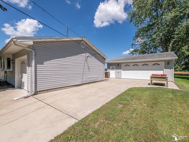 12388 N Suder Rd, La Salle, MI 48145 - view of home's exterior with a detached garage and a lawn