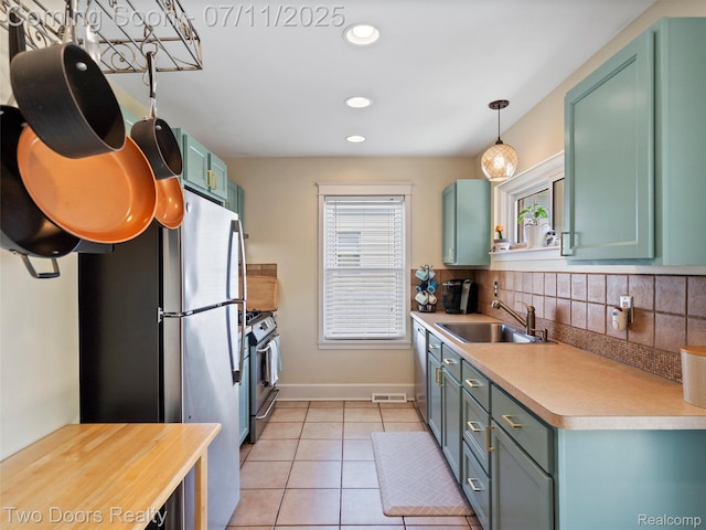 30 Beebe St, Lake Orion, MI 48362 - kitchen with stainless steel appliances, light tile patterned flooring, light countertops, recessed lighting, and backsplash