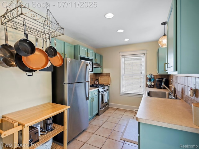 30 Beebe St, Lake Orion, MI 48362 - kitchen with appliances with stainless steel finishes, decorative backsplash, light tile patterned floors, recessed lighting, and light countertops
