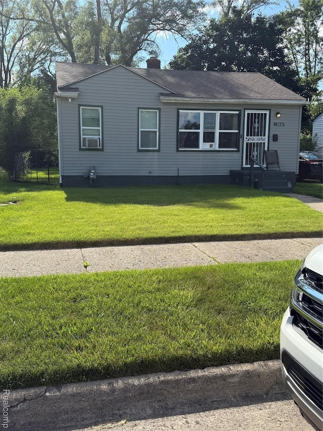 19361 Lindsay St, Detroit, MI 48235 - view of front of home featuring a front lawn, a chimney, and roof with shingles