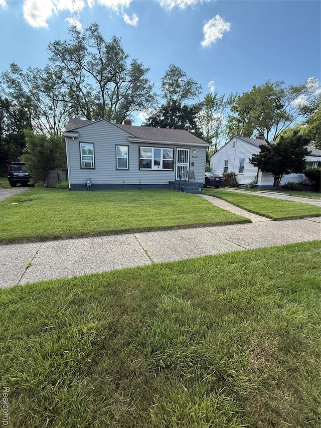 19361 Lindsay St, Detroit, MI 48235 - view of front of property with a front yard and a chimney