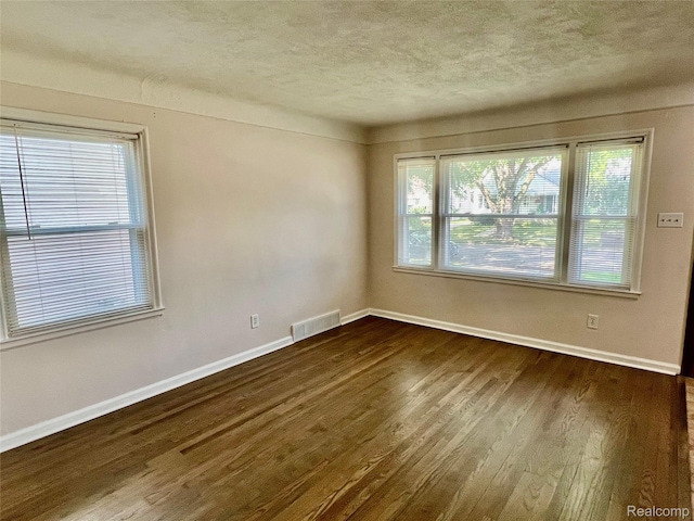 1992 Griffith Ave, Berkley, MI 48072 - unfurnished room with a textured ceiling, dark wood finished floors, and plenty of natural light