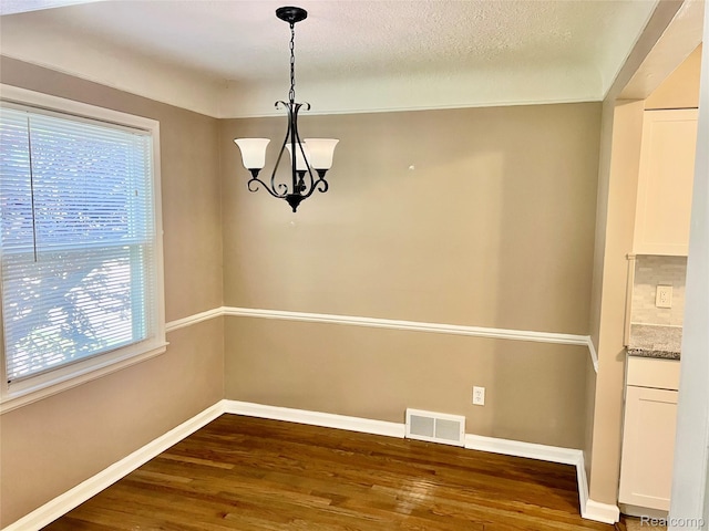 1992 Griffith Ave, Berkley, MI 48072 - unfurnished dining area with dark wood-style flooring and a chandelier