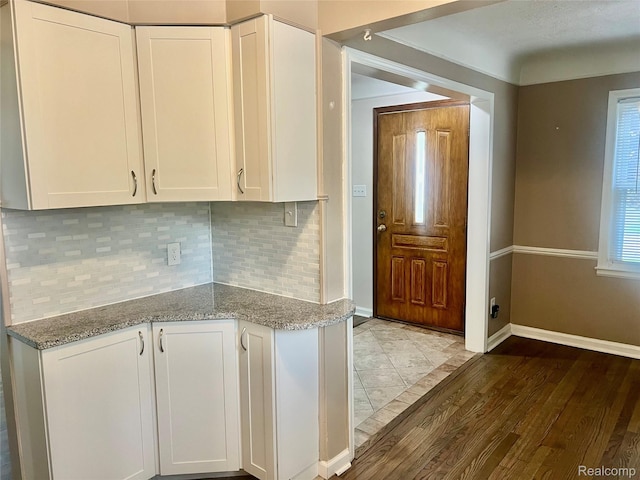 1992 Griffith Ave, Berkley, MI 48072 - kitchen with light wood-style flooring, white cabinets, light stone counters, and backsplash