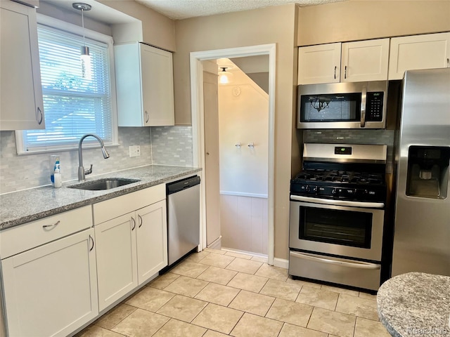 1992 Griffith Ave, Berkley, MI 48072 - kitchen featuring appliances with stainless steel finishes, tasteful backsplash, and white cabinetry