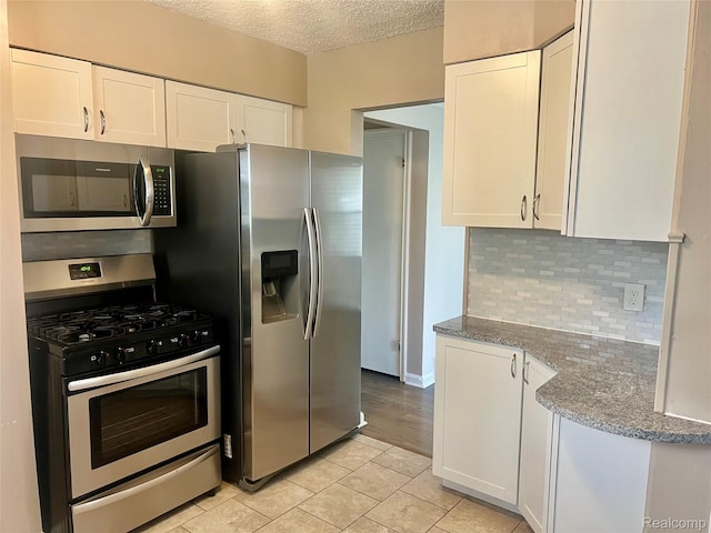 1992 Griffith Ave, Berkley, MI 48072 - kitchen featuring appliances with stainless steel finishes, white cabinets, stone counters, and a textured ceiling