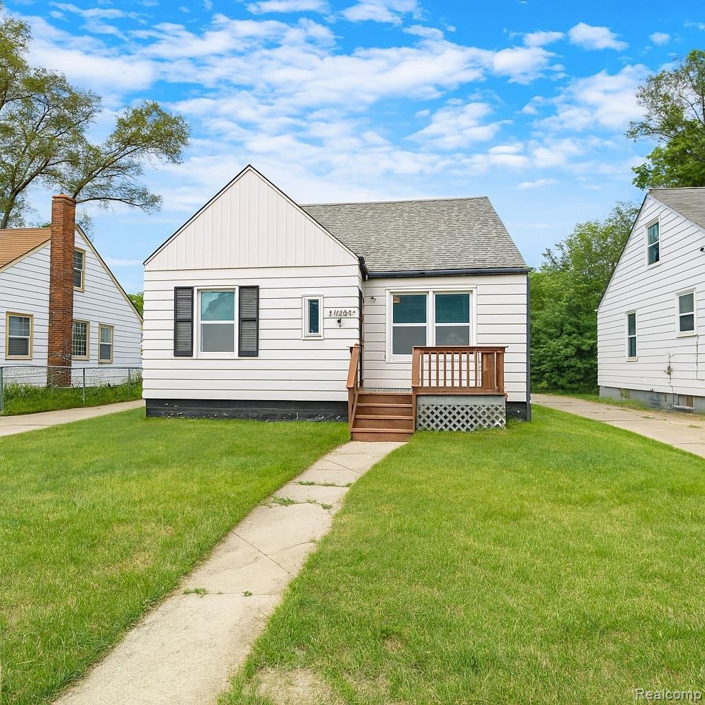 19943 Southfield Fwy, Detroit, MI 48235 - bungalow-style house featuring a shingled roof, a wooden deck, and board and batten siding
