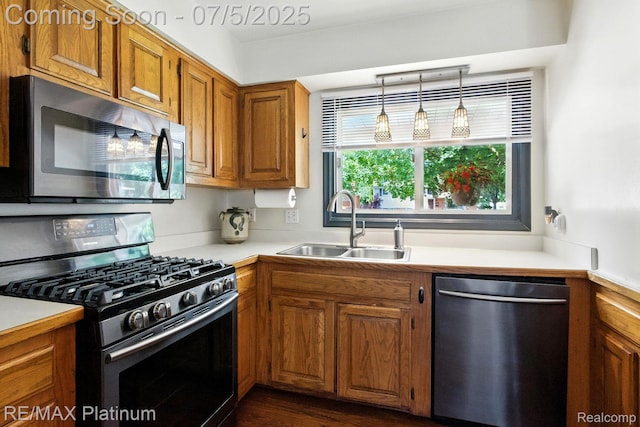 11634 Spicer Dr, Plymouth, MI 48170 - kitchen with stainless steel appliances, brown cabinets, light countertops, and hanging light fixtures