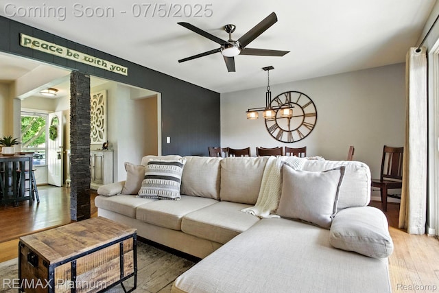 11634 Spicer Dr, Plymouth, MI 48170 - living room with a ceiling fan, light wood finished floors, and a chandelier