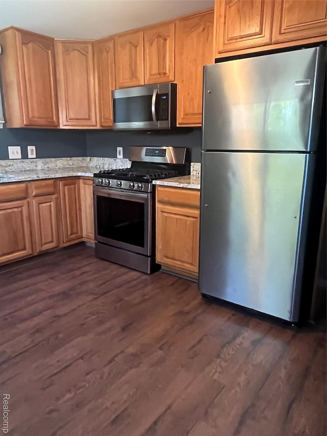 808 Lamay Ave, Ypsilanti, MI 48198 - kitchen featuring appliances with stainless steel finishes, dark wood-style flooring, and light stone counters