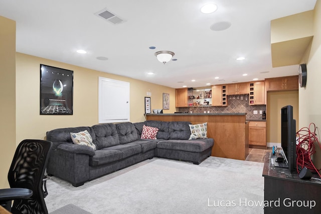 1003 Kusterer Dr NW, Grand Rapids, MI 49534 - living room with recessed lighting, bar, and light colored carpet